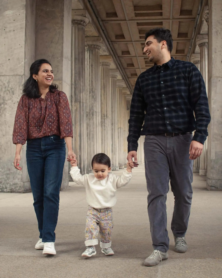 Family walking together through a colonnade