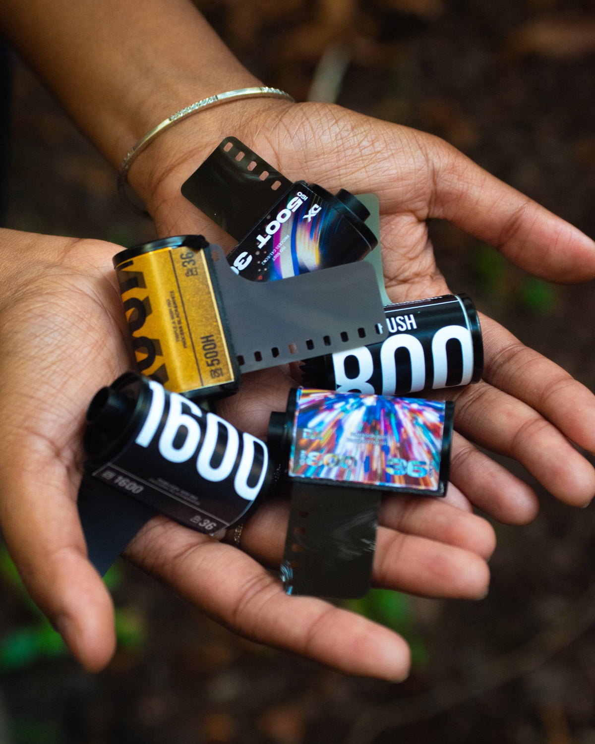 Hands holding film rolls of different formats