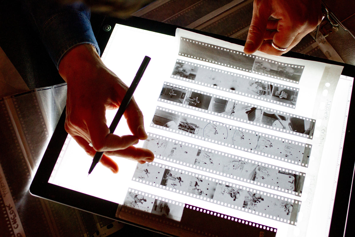 Photographic negatives being inspected on a light table