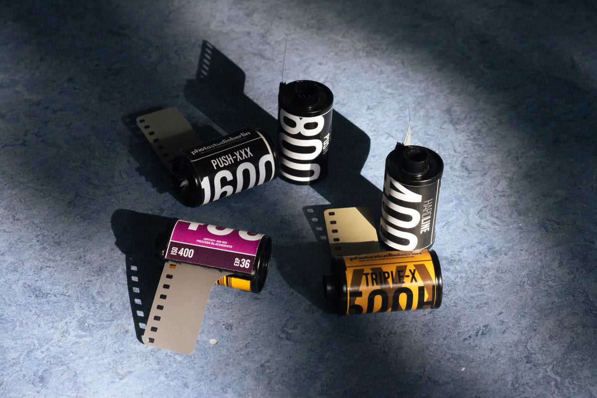 Colour and black-and-white film rolls arranged together