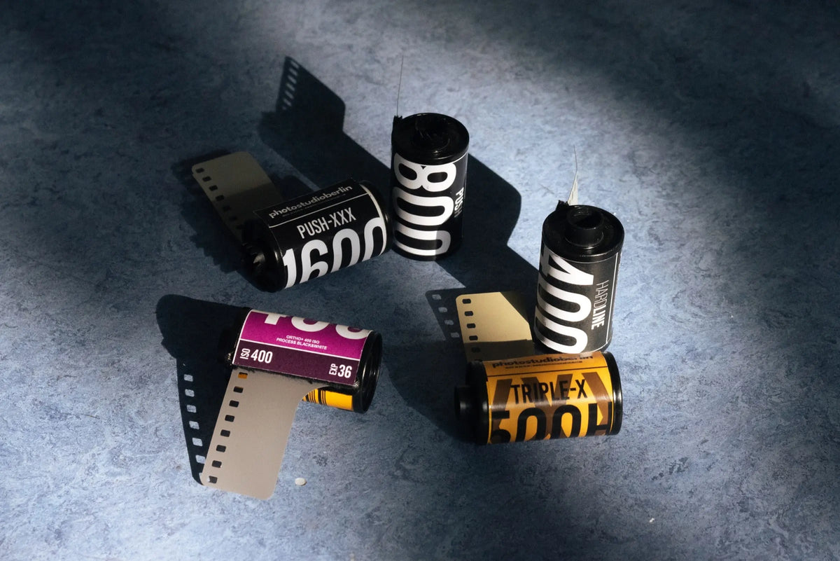 Colour and black-and-white film rolls arranged together
