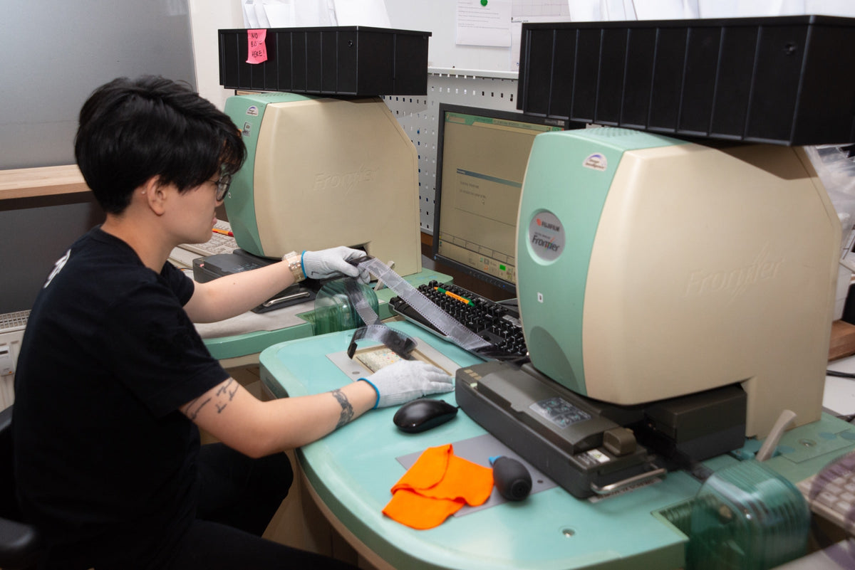 Technician working at a film scanning station