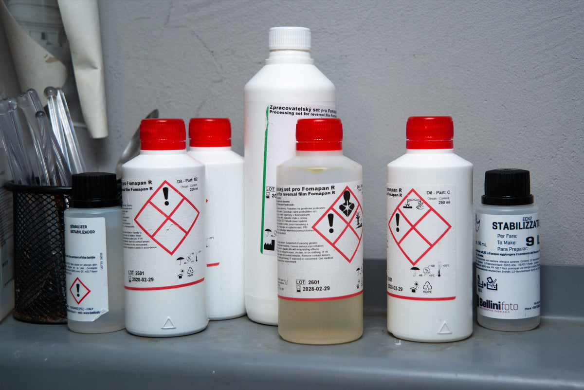 Labelled photographic chemical containers in the laboratory