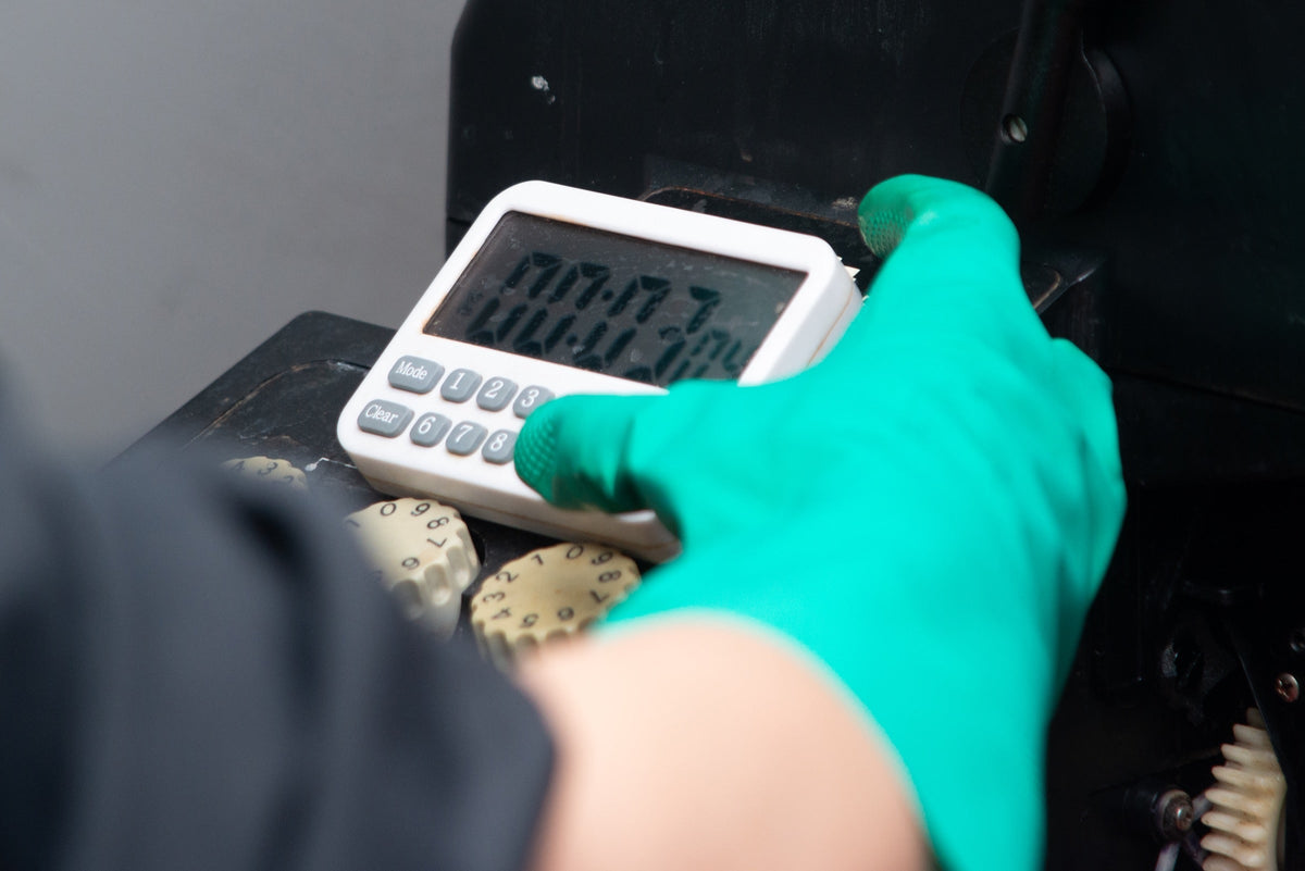 Technician using a timer during film development