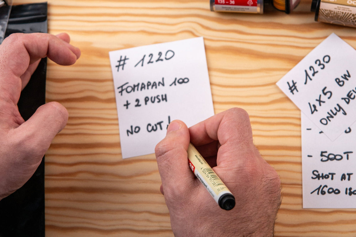 Hand writing exposure and processing information for film rolls