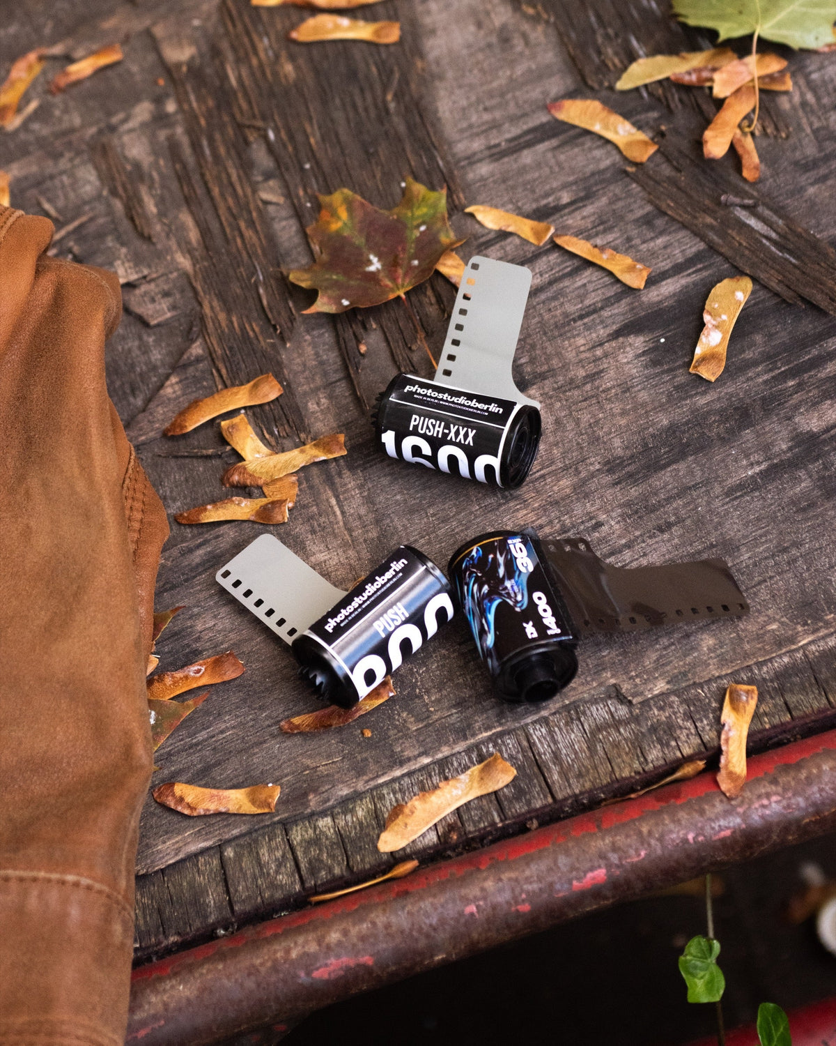 Film rolls with visible ISO ratings on an outdoor bench