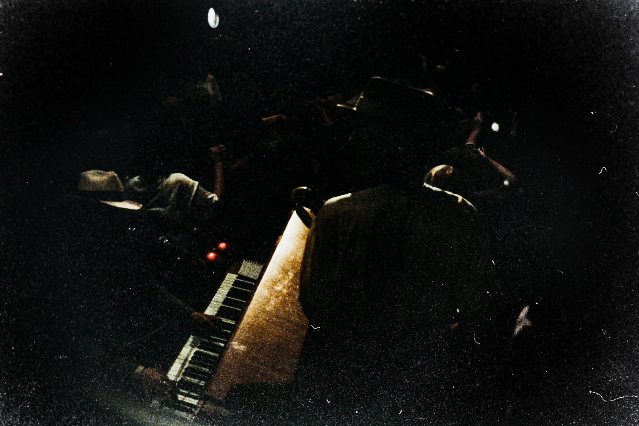Underexposed film scan with very dark shadows, heavy grain and limited visible detail