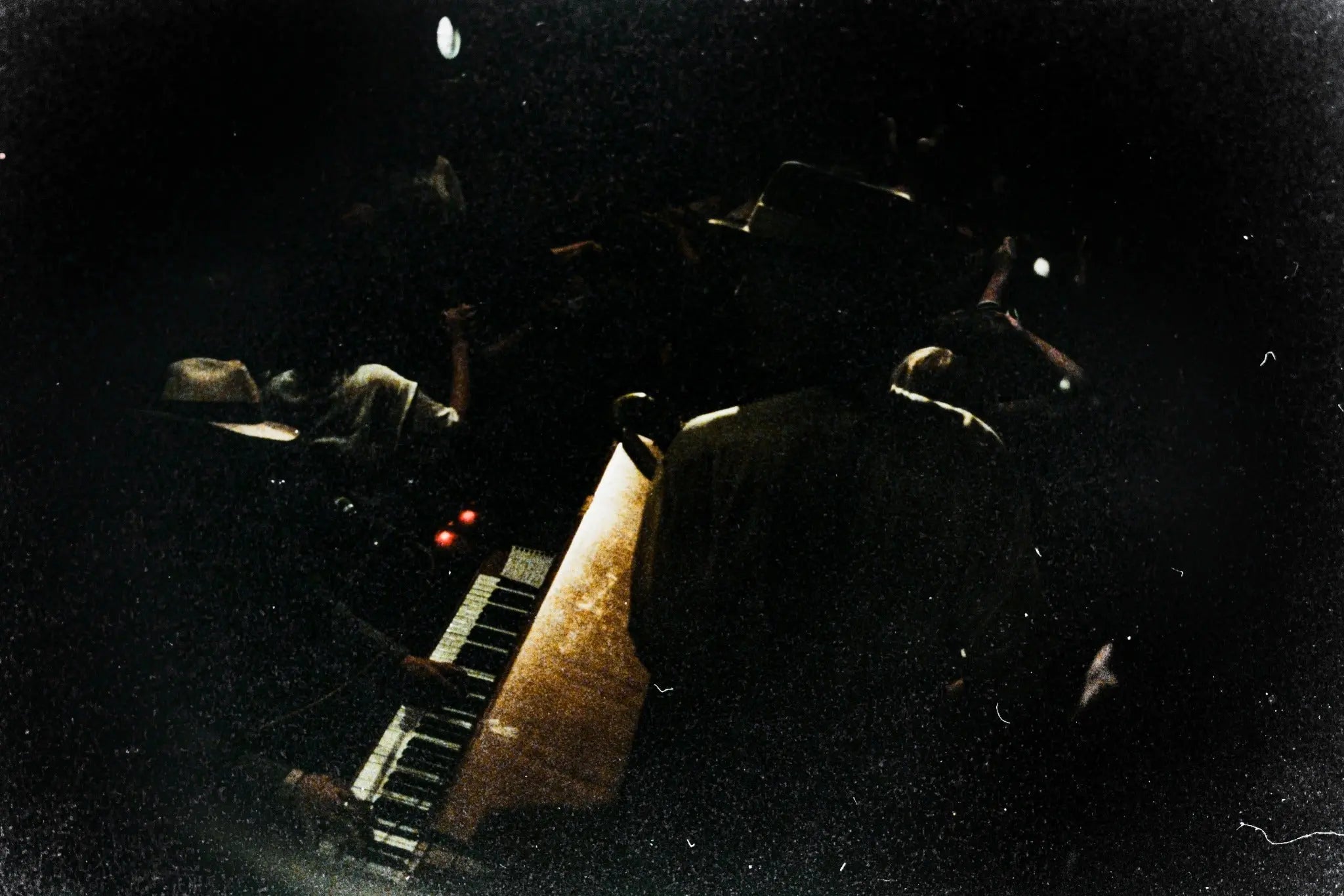 Underexposed film scan with very dark shadows, heavy grain and limited visible detail