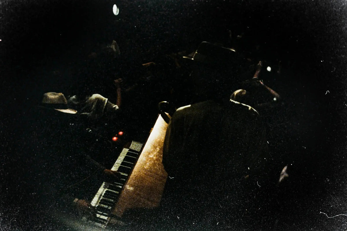 Underexposed film scan with very dark shadows, heavy grain and limited visible detail