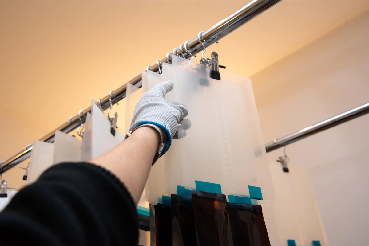 Gloved hand hanging developed film to dry