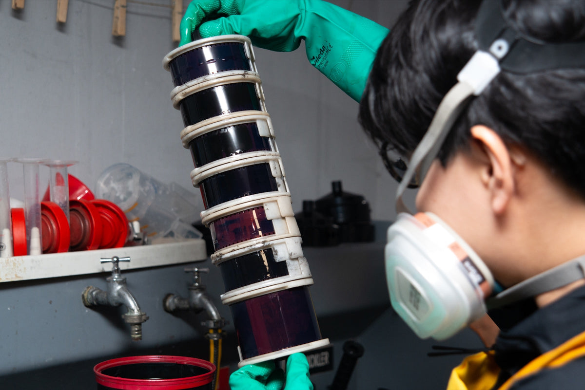 Technician inspecting reels during film development