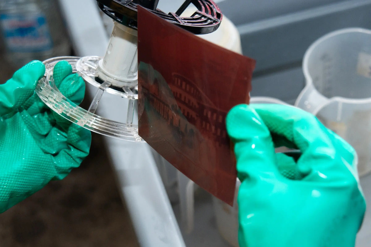 Developed colour negative film held for inspection in the laboratory