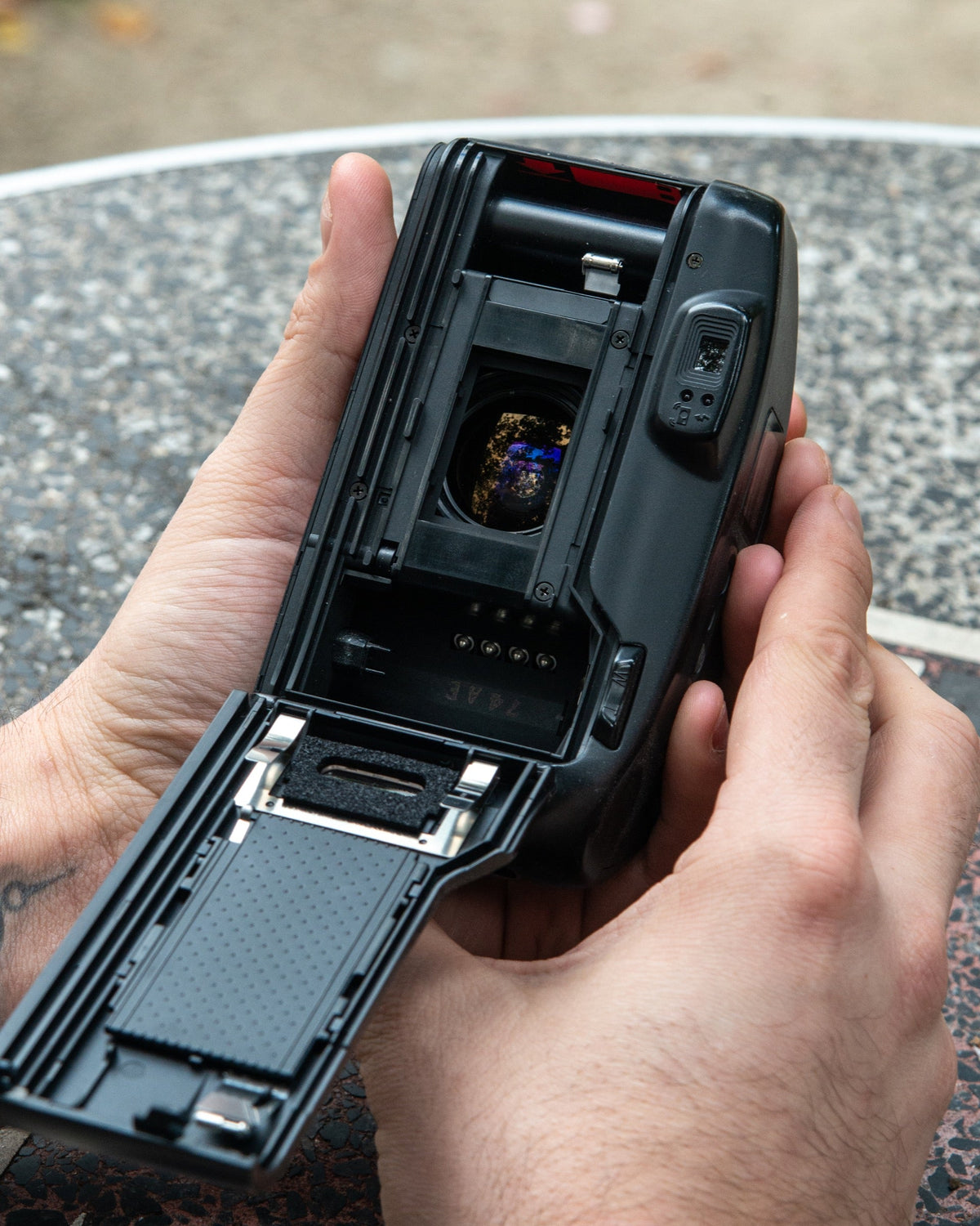 Open compact camera showing the film chamber