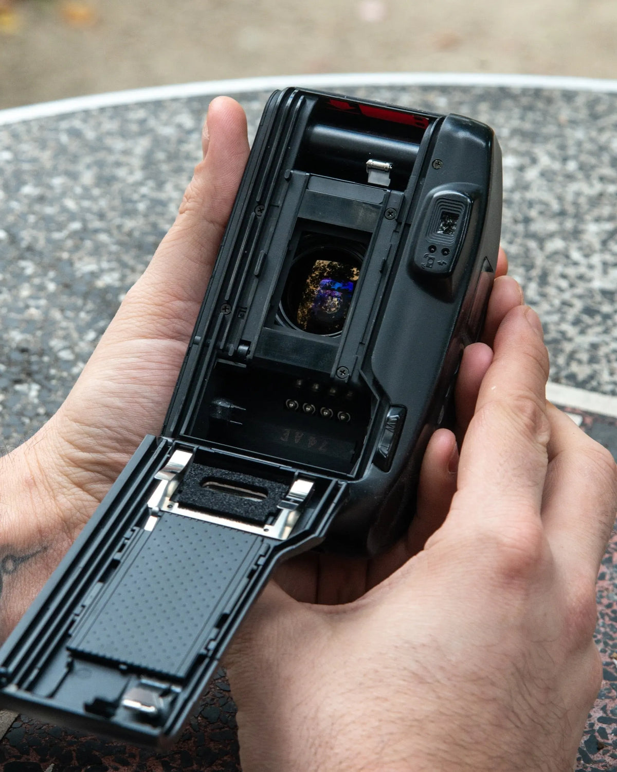 Open compact camera showing the film chamber