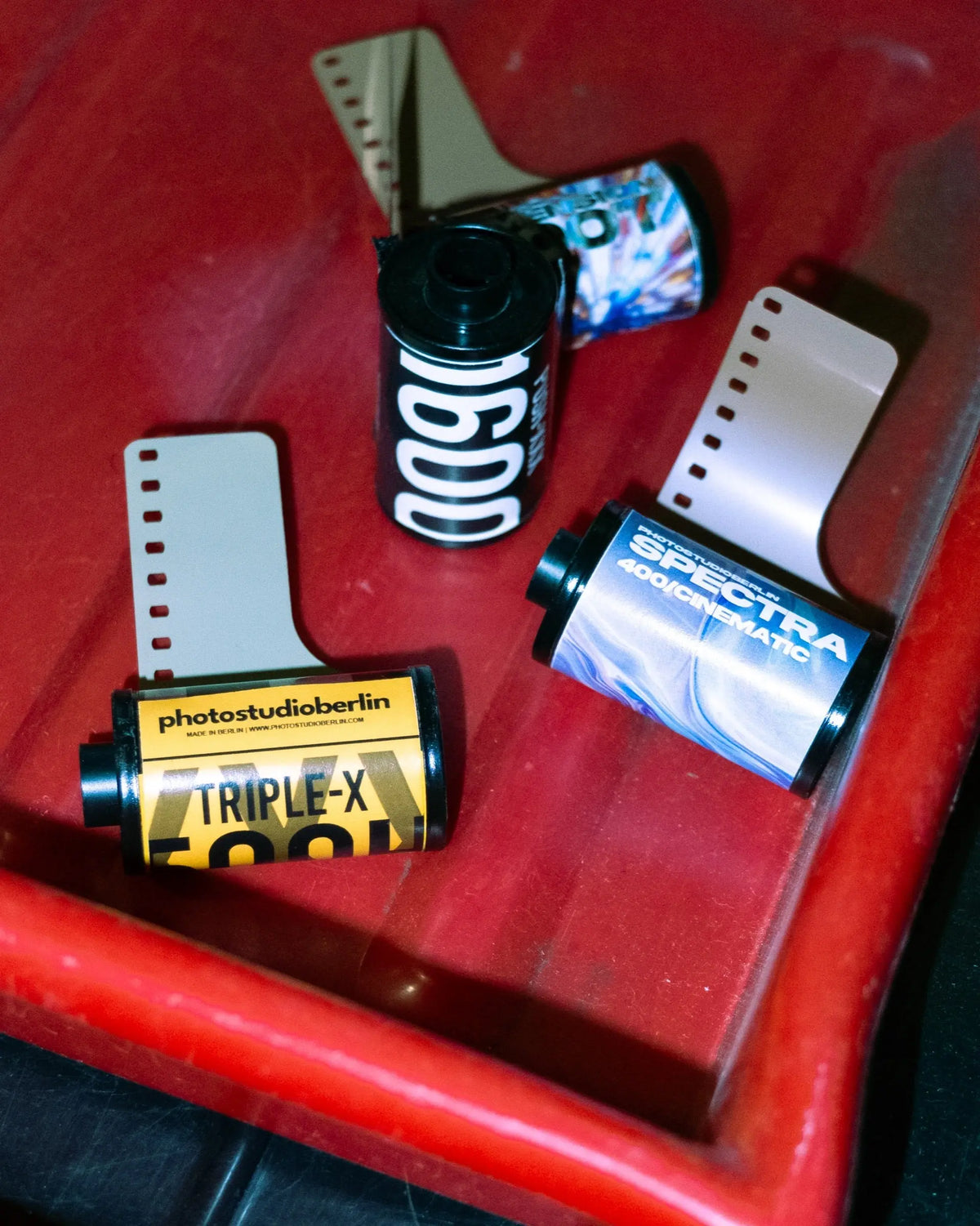 Assorted colour and black-and-white film rolls on a red chair