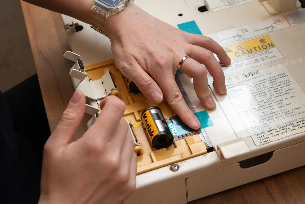 Hands preparing a film cassette at the laboratory loading station
