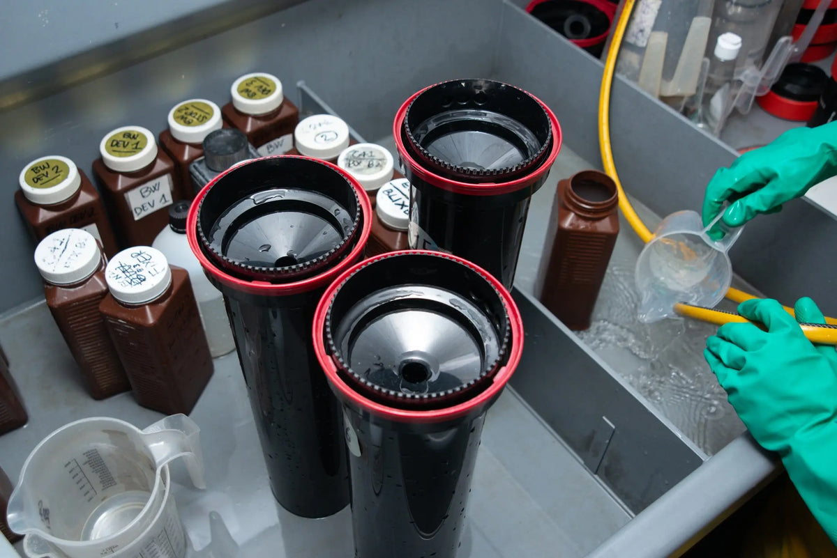 Film development tanks and labelled chemistry at the wet bench at Berlin Photo Studio