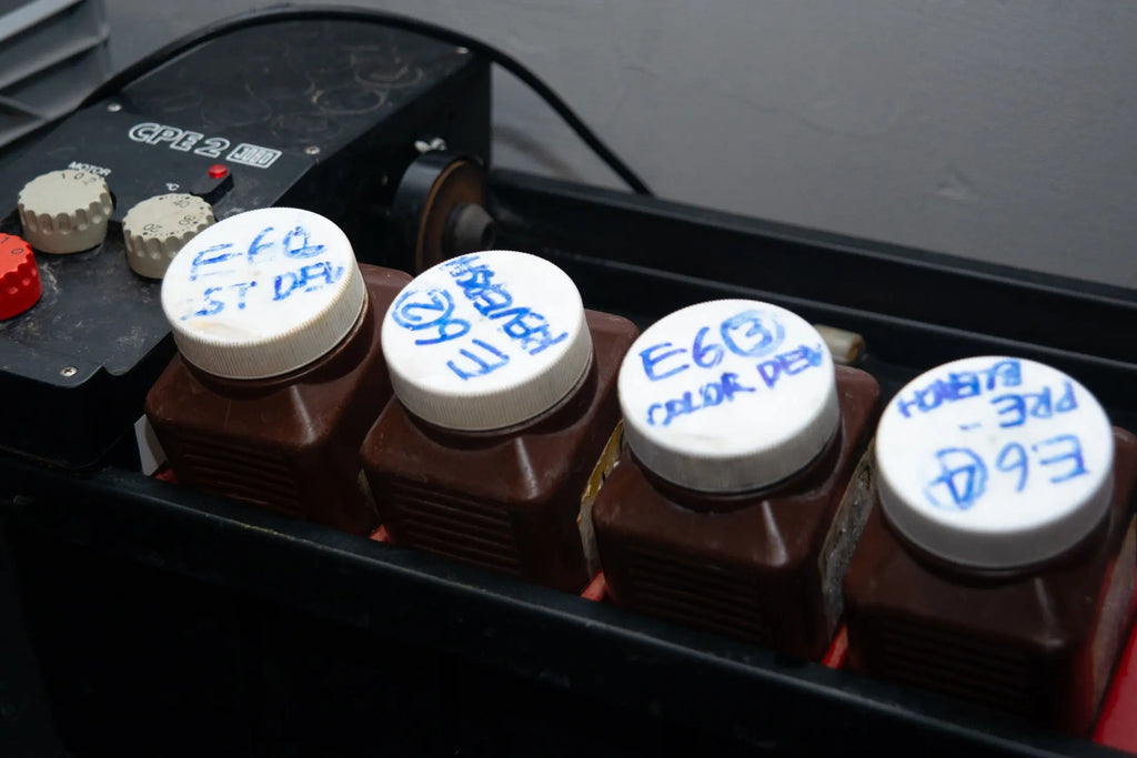 E-6 chemistry bottles beside the JOBO processor controls at Berlin Photo Studio