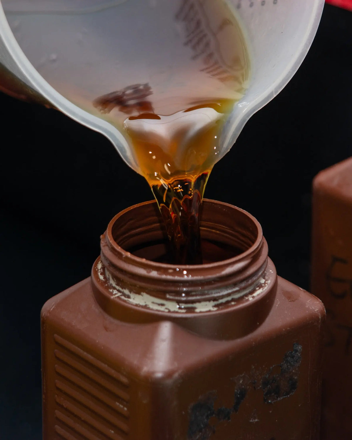 Processing liquid being poured into a storage bottle at Berlin Photo Studio
