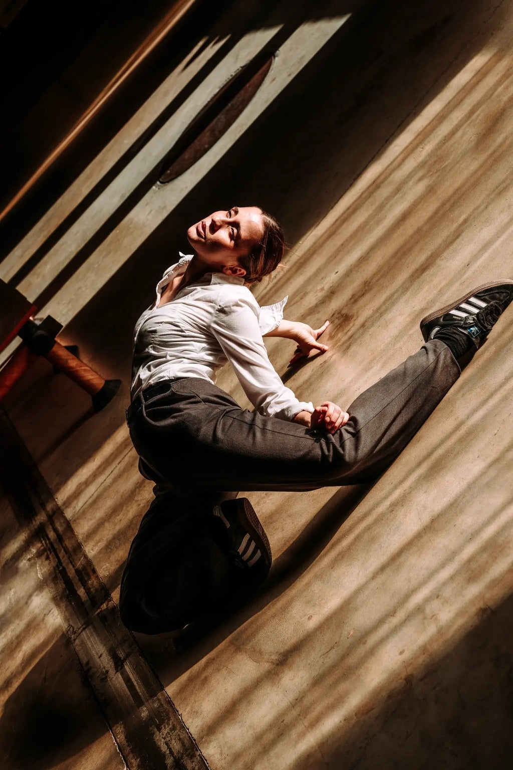 Creative dancer portrait with dramatic sunlight and movement in Berlin