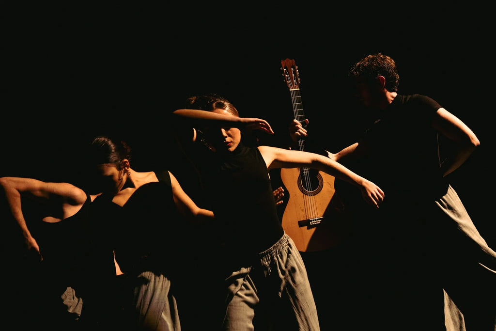 Performance photography in Berlin showing dancers and a guitarist on stage