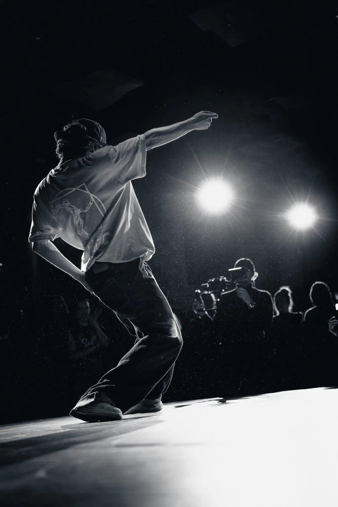 Black and white stage performance photograph of a dancer under spotlights in Berlin